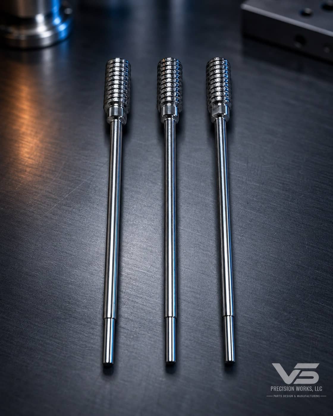 Three polished Swiss-turned threaded stainless shafts